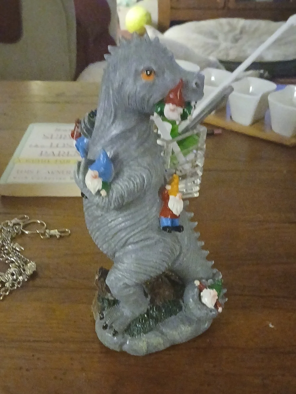 Gray Godzilla-Style Figurine with Colorful Garden Gnomes